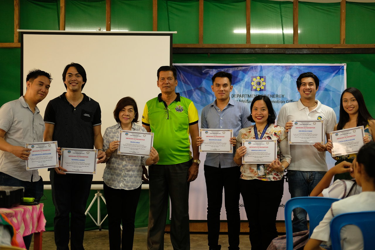 Lourdes National High OIC Benigno Clarabal (center) awards Certificates of Recognition to the resource speakers of the Department of Energy’s ENEReady Program.