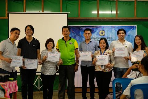 Lourdes National High OIC Benigno Clarabal (center) awards Certificates of Recognition to  the resource speakers of the Department of Energy’s ENEReady Program. 