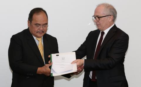 Energy Undersecretary Donato D. Marcos accepts the International Atomic Energy Agency (IAEA)-Integrated Nuclear Infrastructure Review (INIR) mission report from IAEA Nuclear Infrastructure Development Section Head Milko Kovachev during the ceremonial turnover at the Makati Shangri-La last Monday, December 17. 