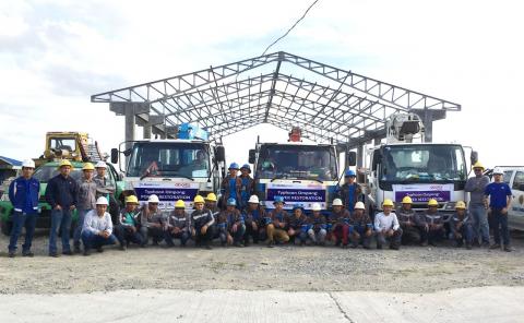 Line personnel alongside their restoration vehicles strike a pose as they were deployed to help in the rehabilitation of typhoon Ompong-hit areas.
